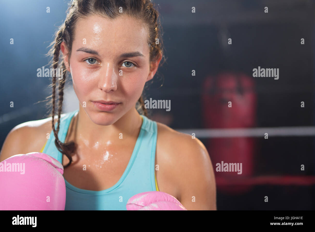 Close-up portrait of young female boxer in boxing ring Stock Photo