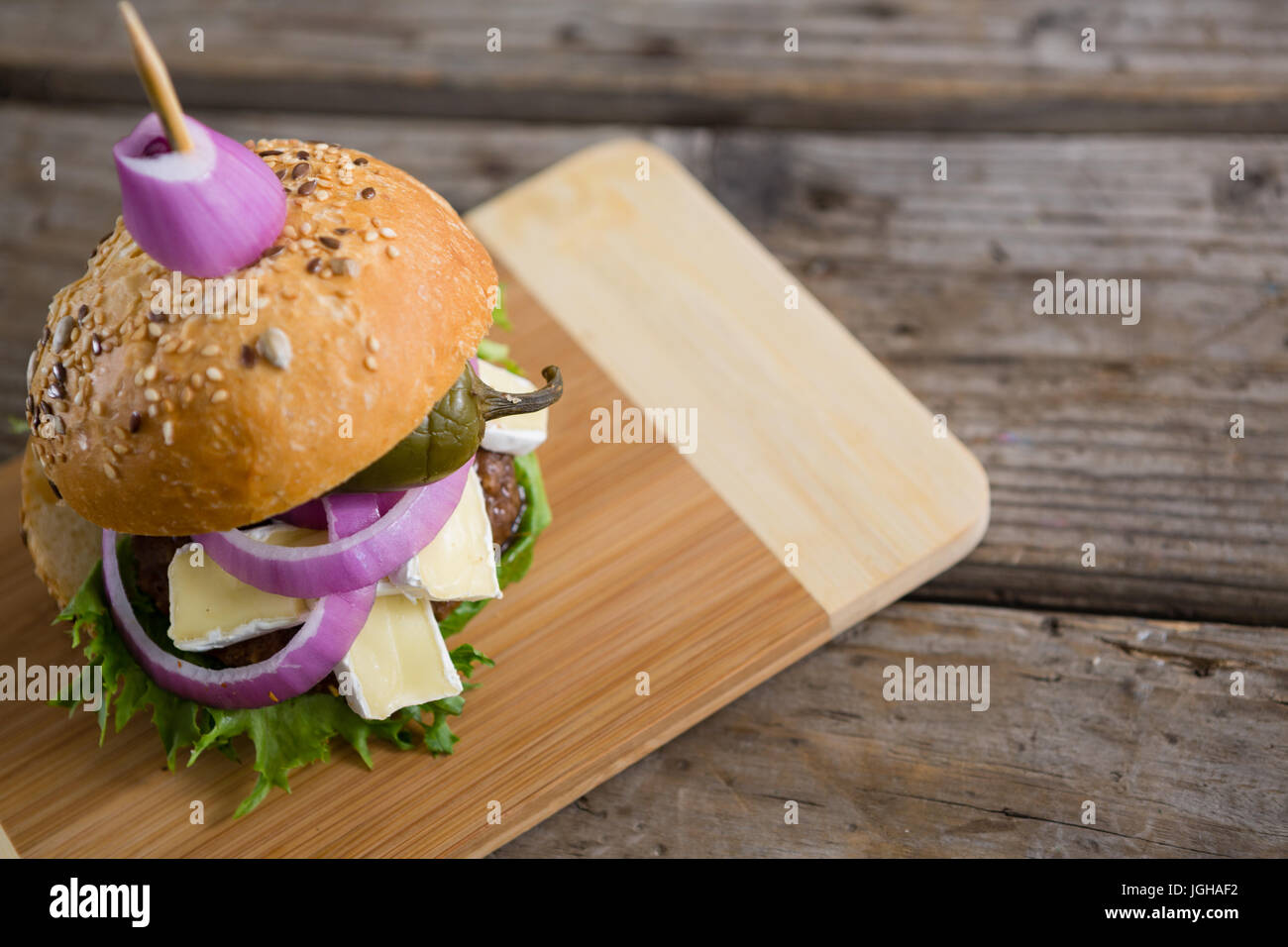 High angle view of burger with cottage cheese on cutting board Stock Photo