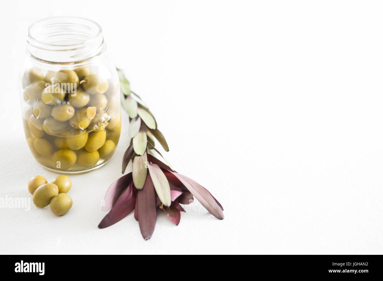 Preservative olives in jar against white background Stock Photo Alamy
