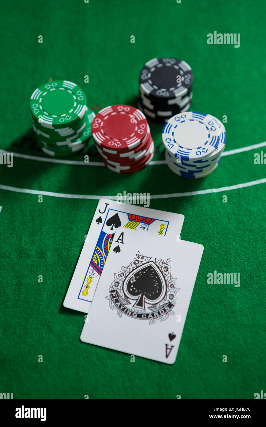 High angle view of spades cards with chips on blackjack table Stock