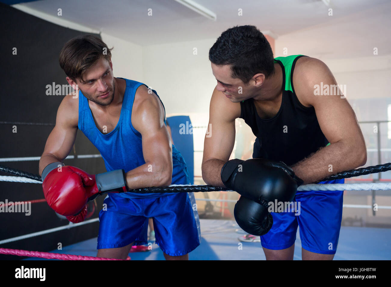 Young male boxers leaning on boxing ring rope Stock Photo Alamy