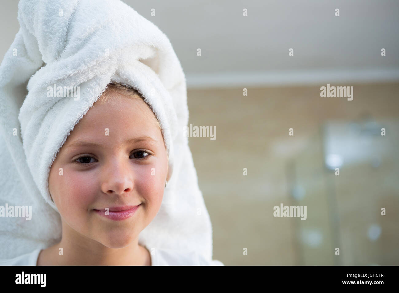 Portrait of girl with hair wrapped in towel bathroom Stock Photo
