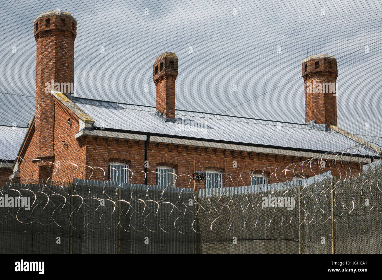 England, Dorset, Dorchester prison, razor wire security round main block Stock Photo