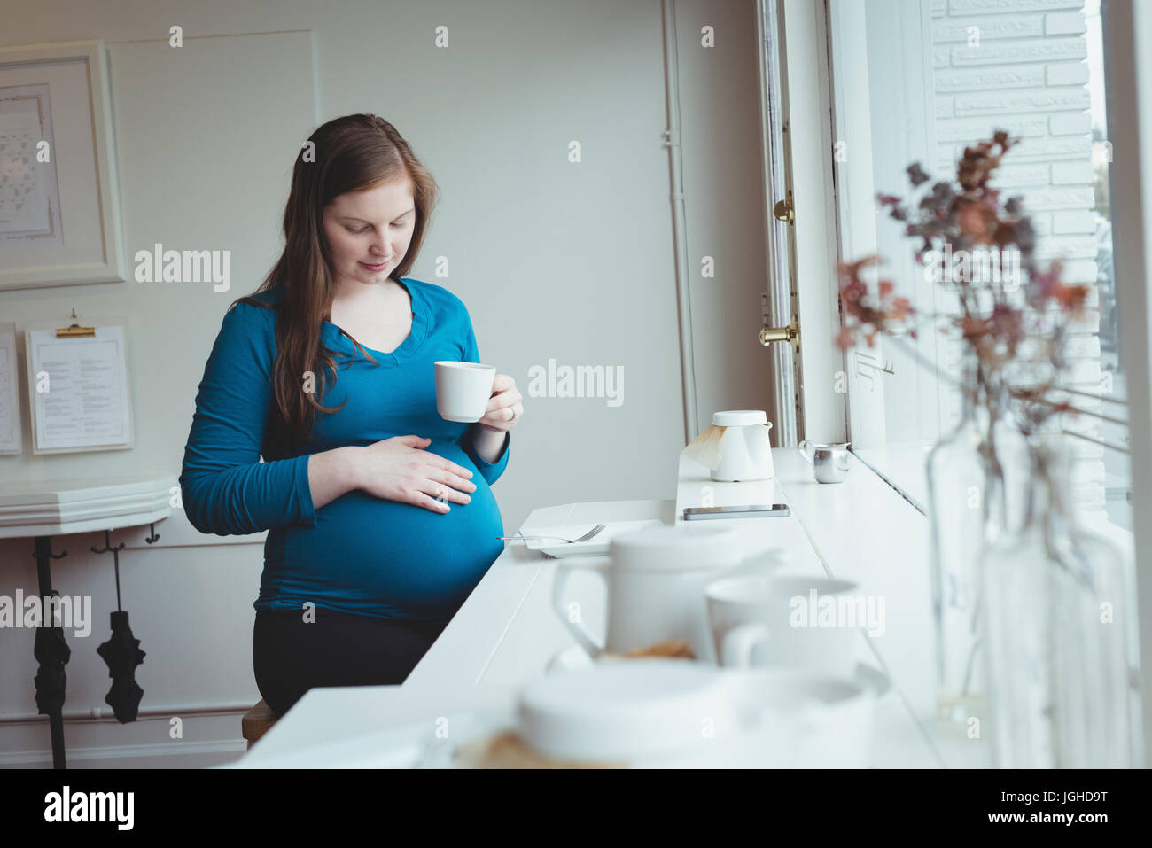 Pregnant woman having coffee in restaurant Stock Photo Alamy