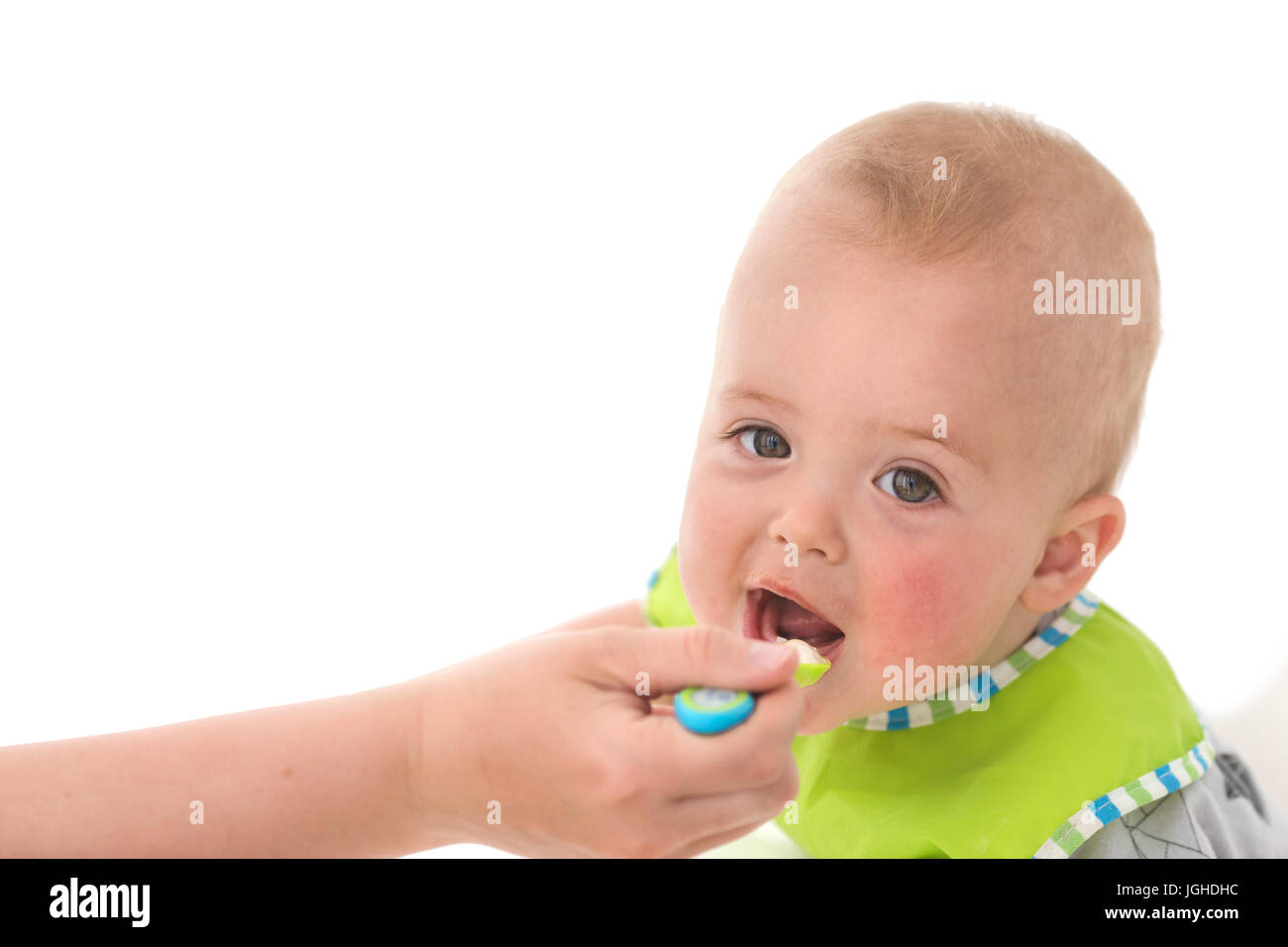 Parent feeding infant child Stock Photo