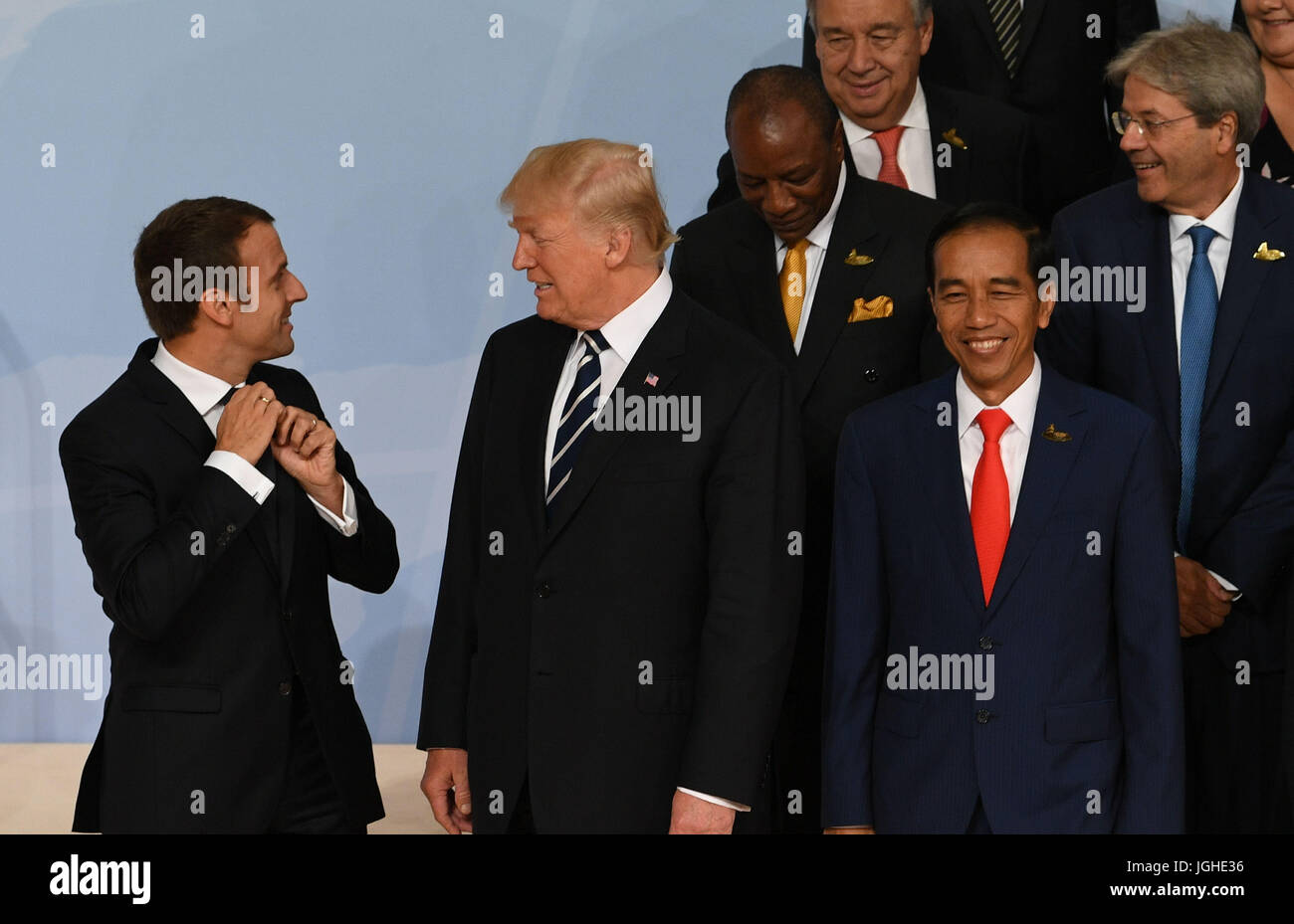 (Left to right) French President Emmanuel Macron, US President Donald Trump and Indonesian president Joko Widodo interact as world leaders pose for a family photo during the G20 summit in Hamburg. Stock Photo