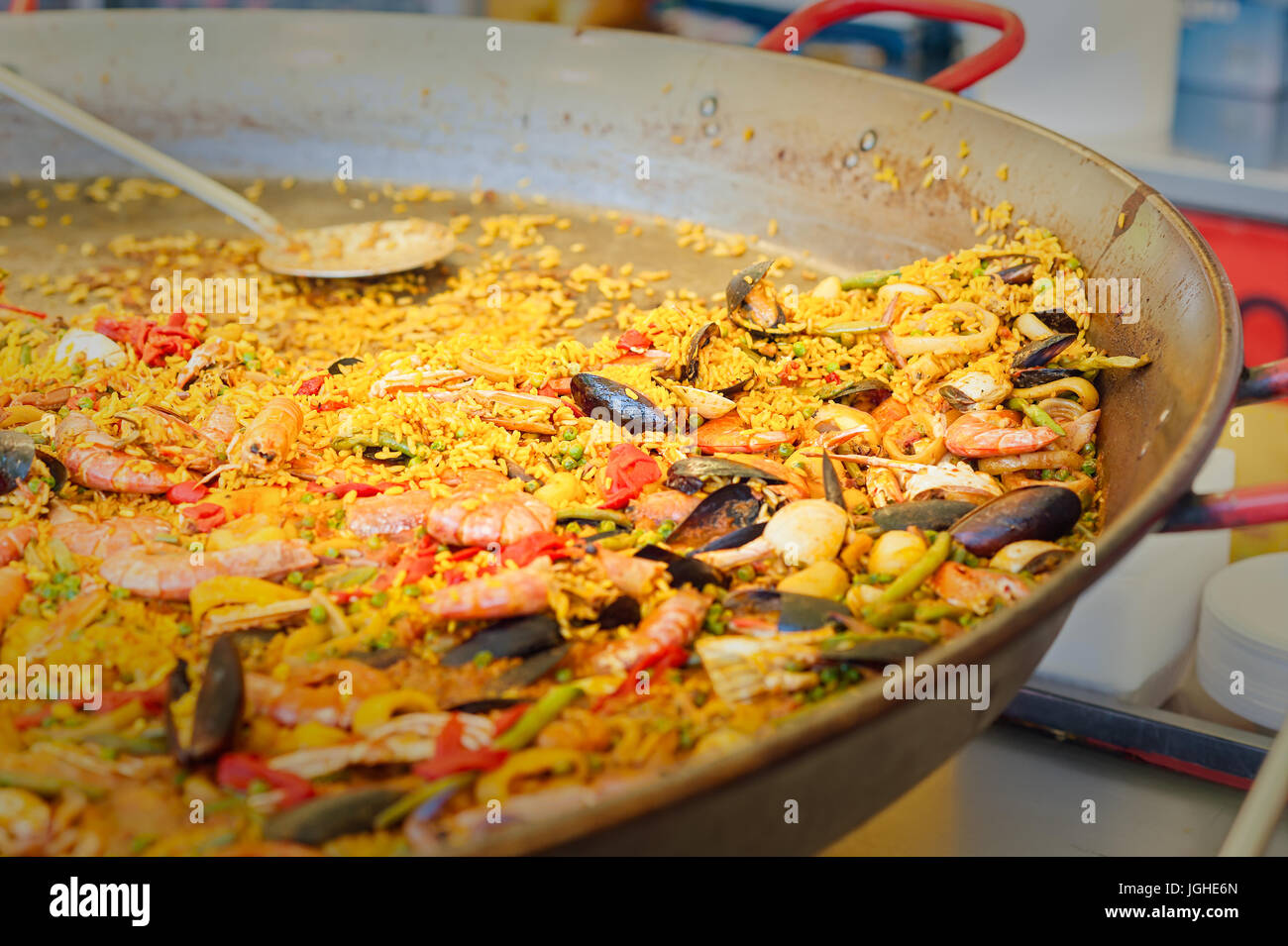 Seafood paella in a paella pan at a street food market  Traditional Spanish paella with seafood and chicken. Stock Photo