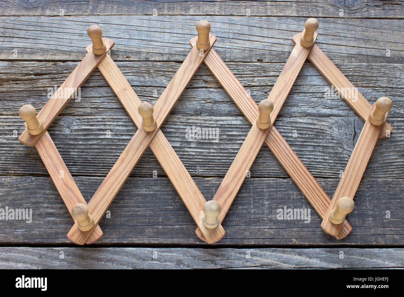 Wooden foldable coat hanger on wooden background Stock Photo