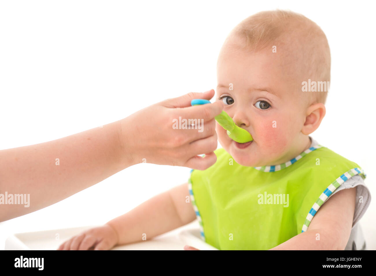 Parent feeding infant child Stock Photo