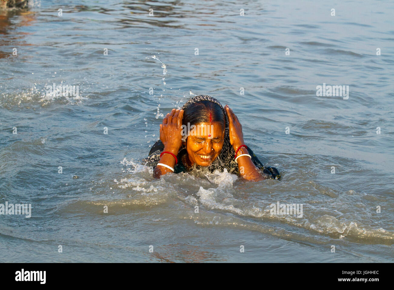 A woman from the Hindu community bathes at the Bay of Bengal during the Rash Mela at Dublarchar in the Eastern Division of Sundarbans forest. Thousand Stock Photo