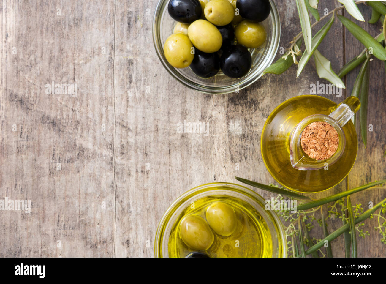 Virgin olive oil in a glass bottle on wooden background Stock Photo - Alamy