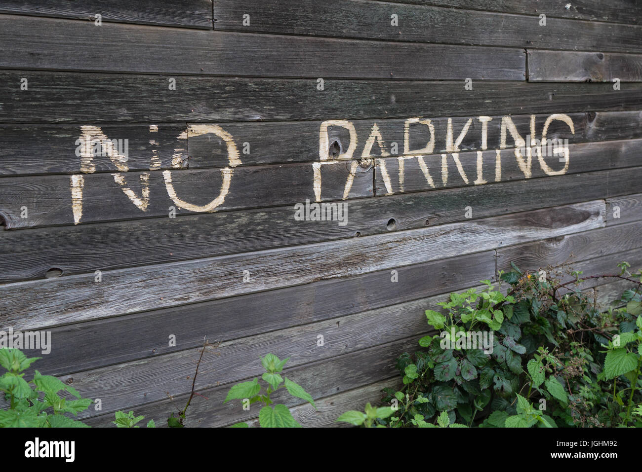No parking sign on old wooden building Stock Photo
