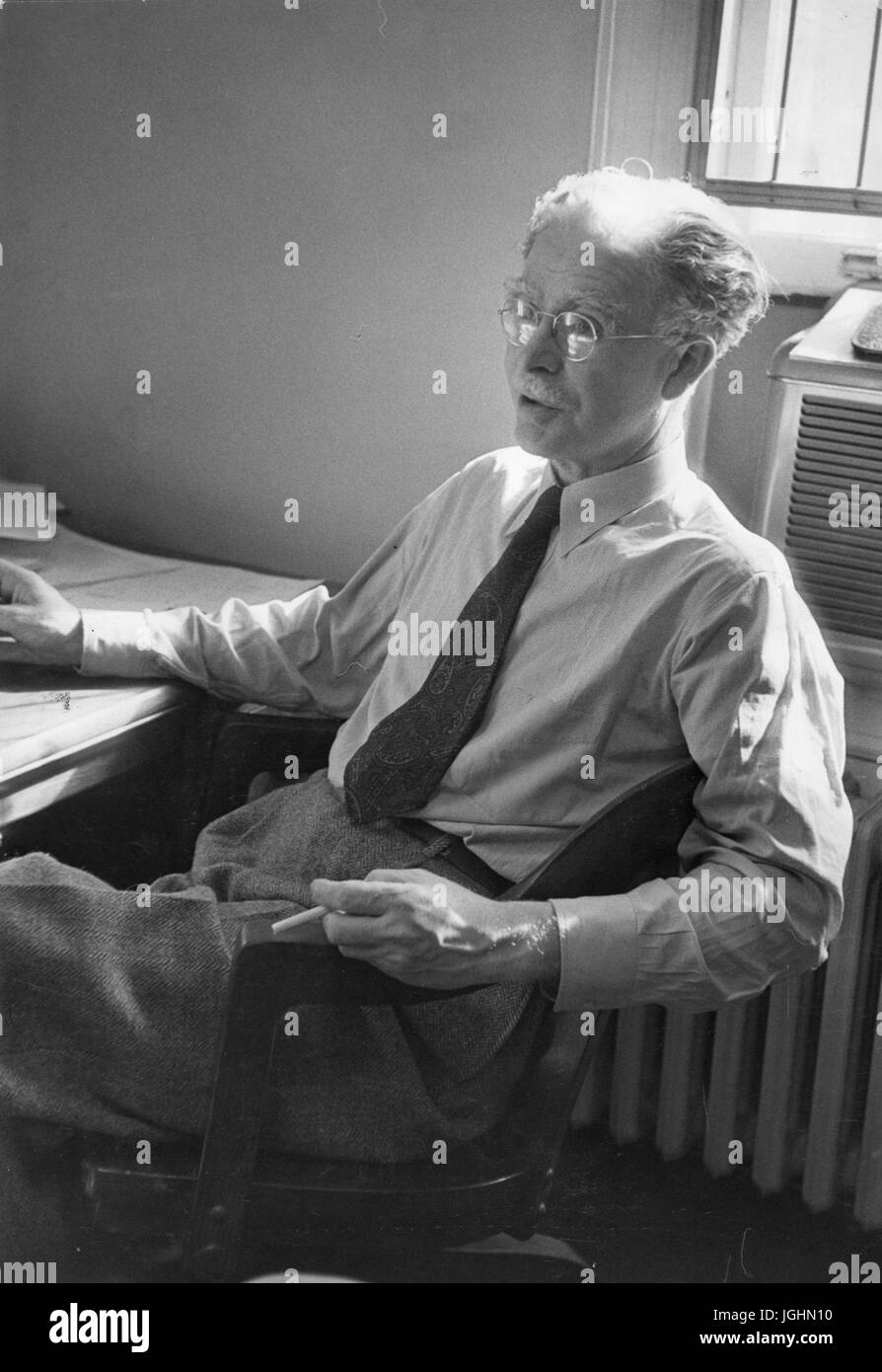 Candid portrait of American astronomer, physicist and geophysicist Scott Ellsworth Forbush sitting at his desk at the Johns Hopkins University, in Baltimore, Maryland, 1952. Stock Photo