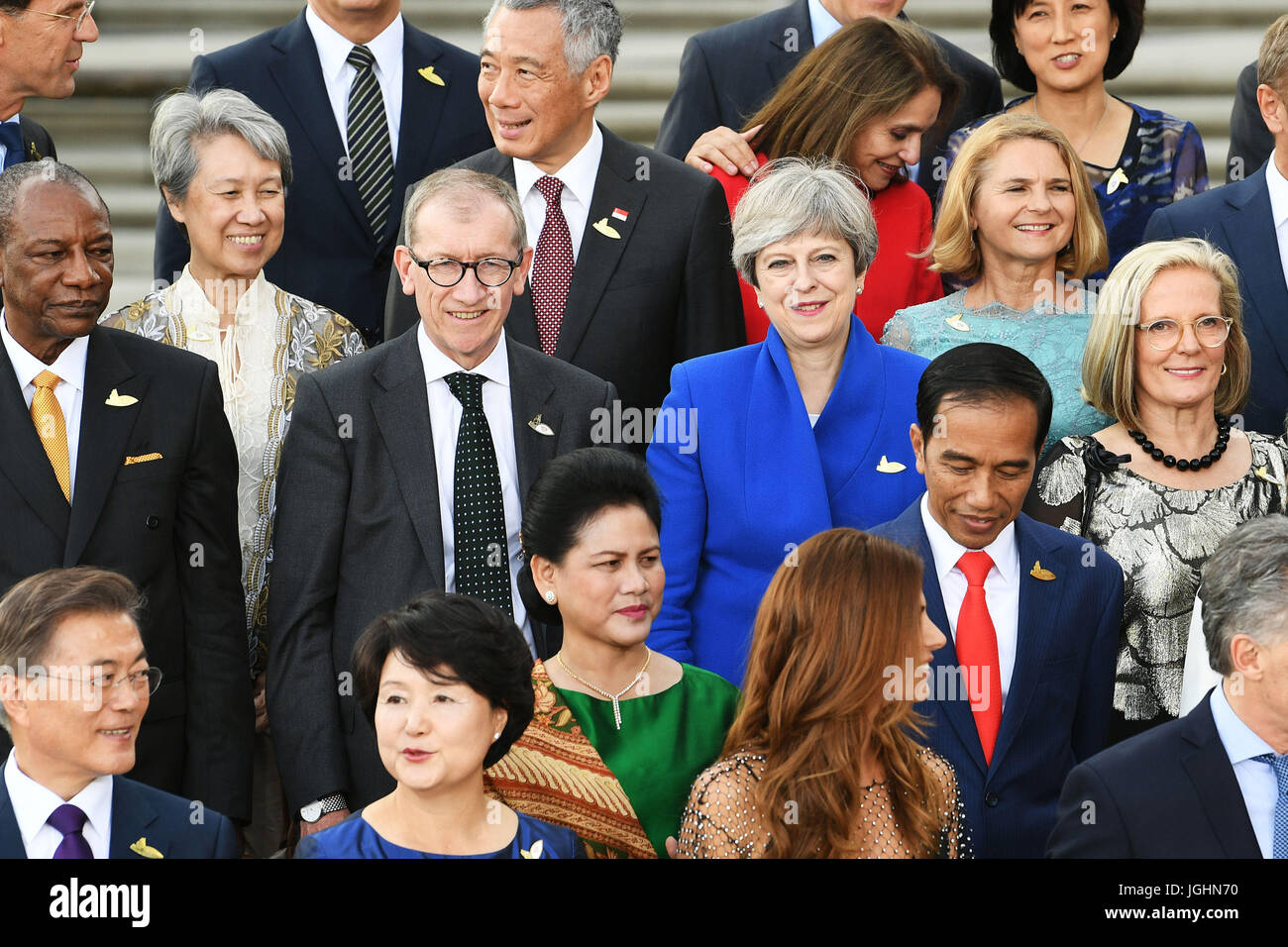 Prime Minister Theresa May and her husband Philip during a group photo as G20 leaders and their spouses arrive to attend a concert at the Elbphilharmonie concert hall in Hamburg. Stock Photo