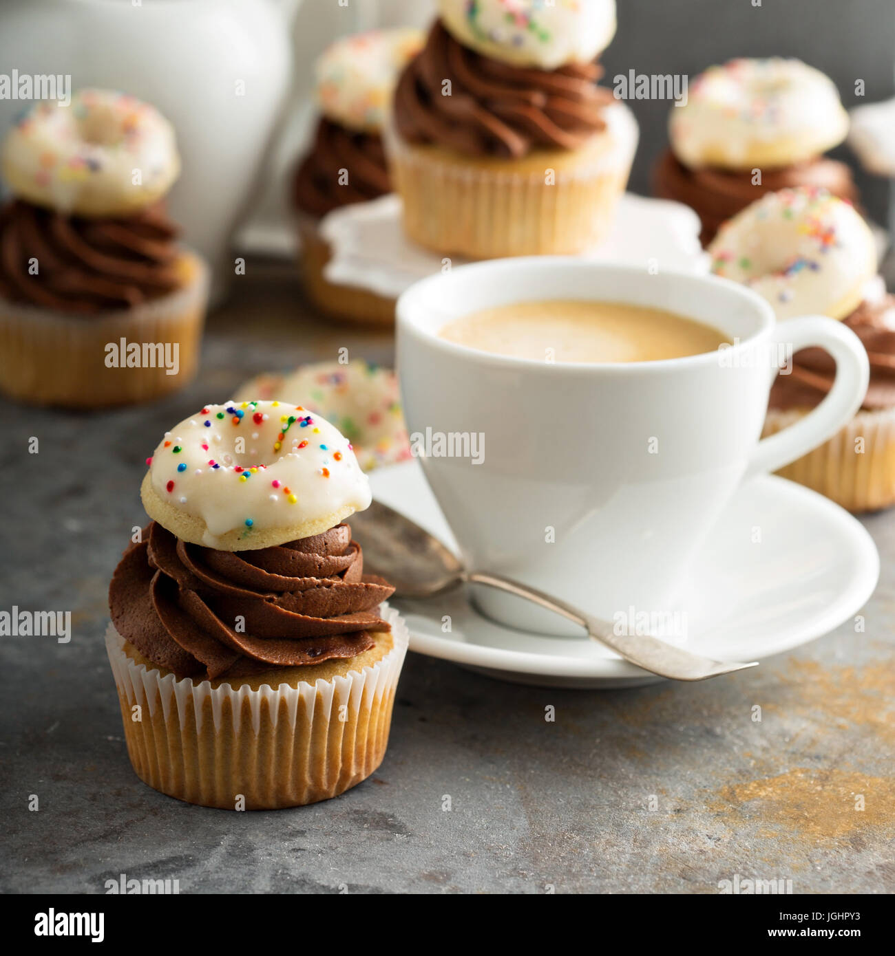 Coffee and cream cupcakes decorated with donuts Stock Photo Alamy