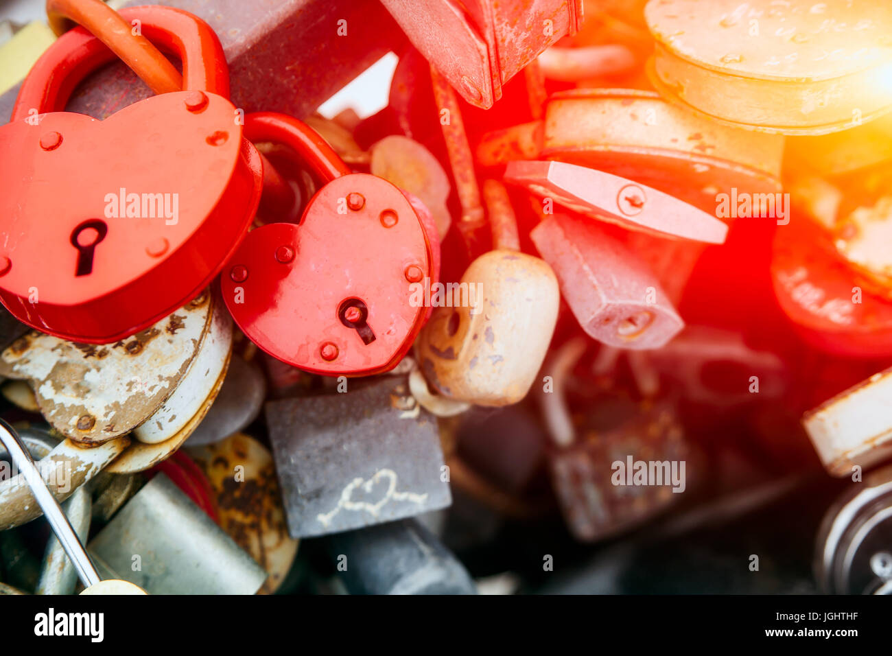 Wedding traditions and traditions of the day of all lovers. Many small metal locks in the shape of hearts Stock Photo