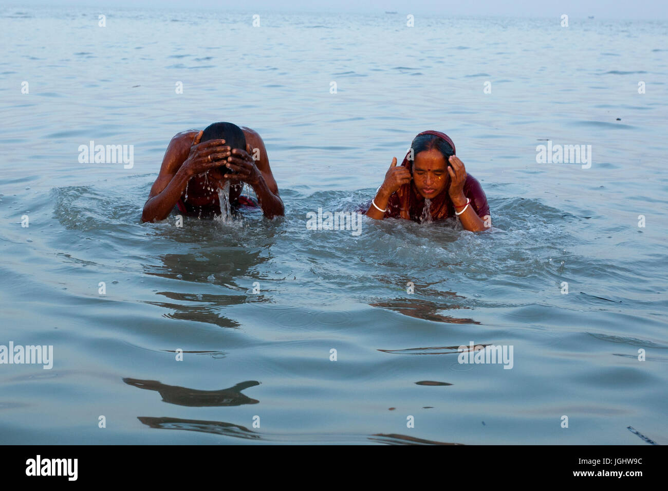 A couple from the Hindu community bathes at the Bay of Bengal during the Rash Mela at Dublarchar in the Eastern Division of Sundarbans forest. Thousan Stock Photo