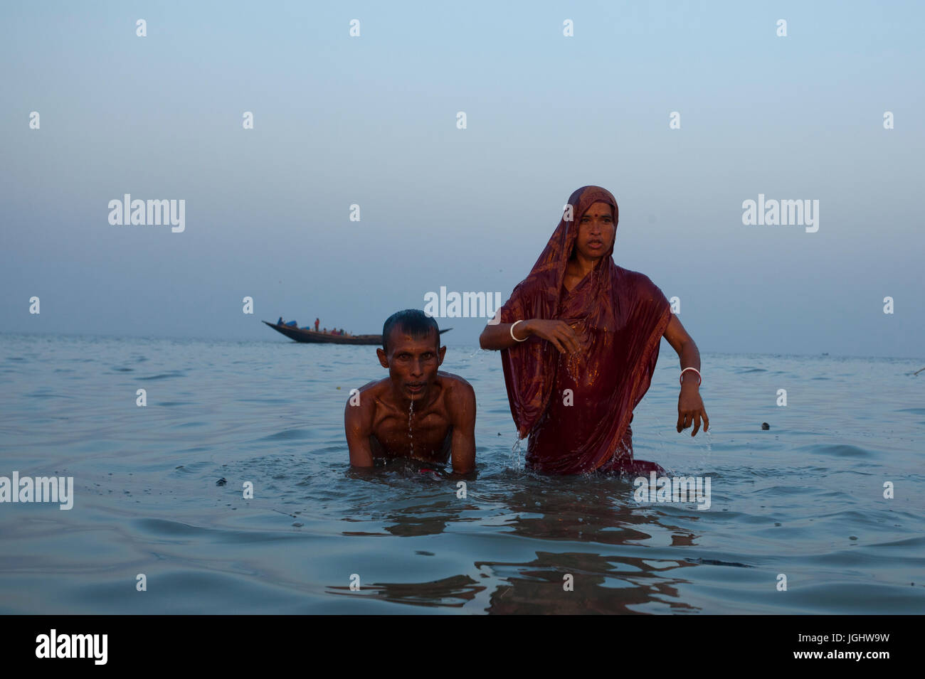 A couple from the Hindu community bathes at the Bay of Bengal during the Rash Mela at Dublarchar in the Eastern Division of Sundarbans forest. Thousan Stock Photo