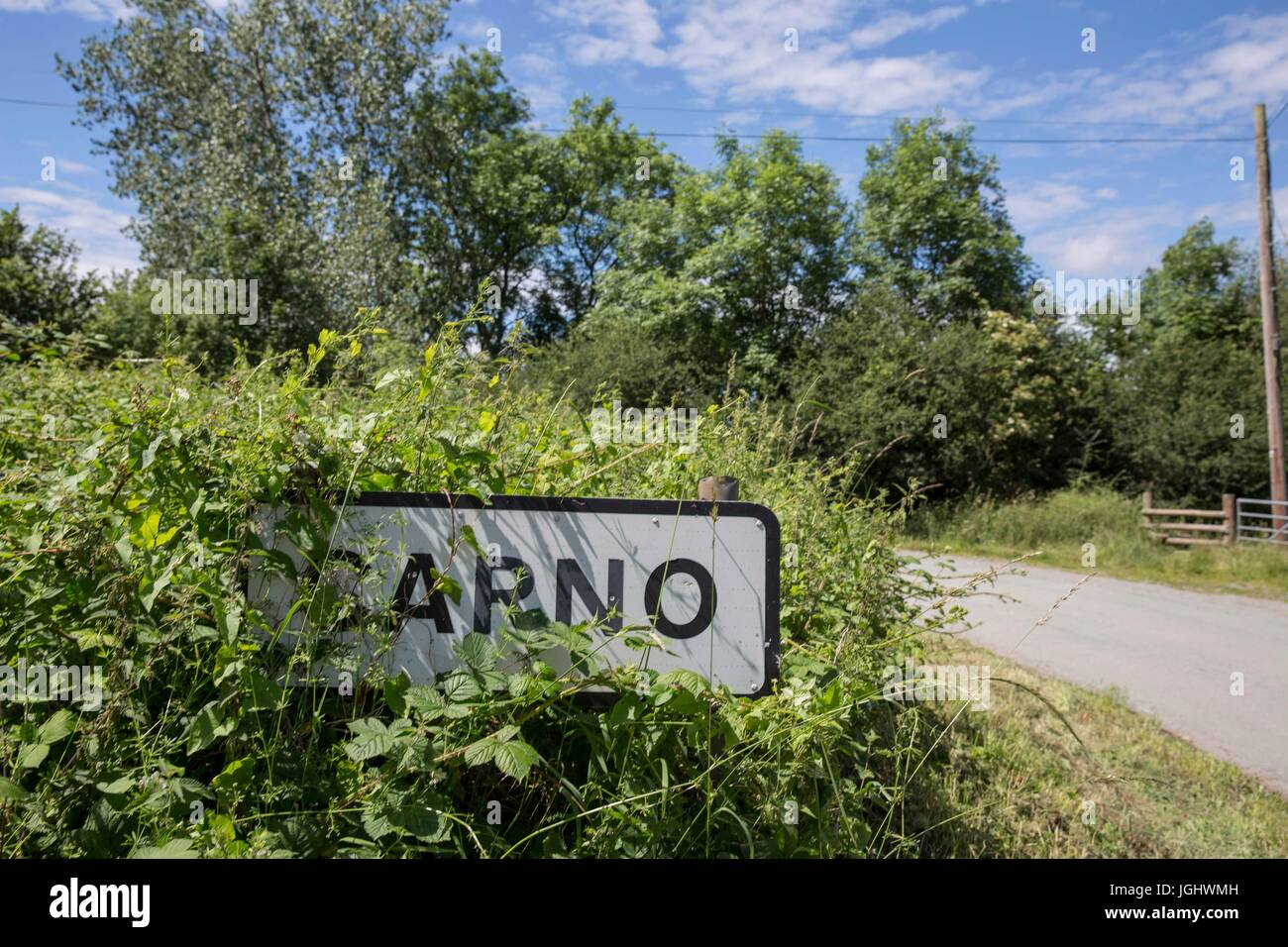 A partially obscured sign-post for the Welsh village of Carno, Powys, Wales, UK. A major stash of LSD is rumoured to be buried in nearby woodland. Stock Photo