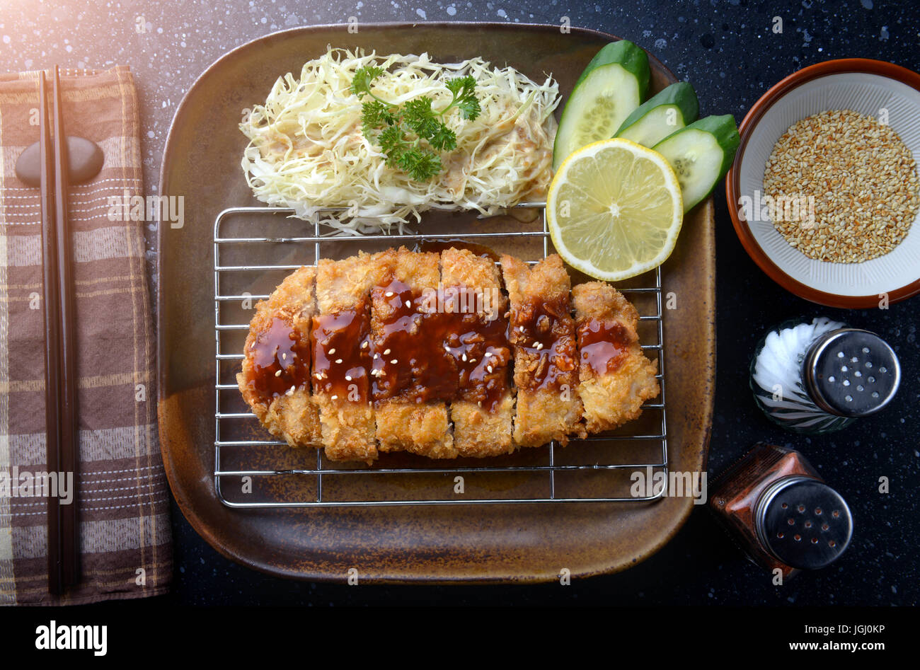 Japanese deep fried pork or tonkatsu with sauce fill on top in studio lighting Stock Photo Alamy
