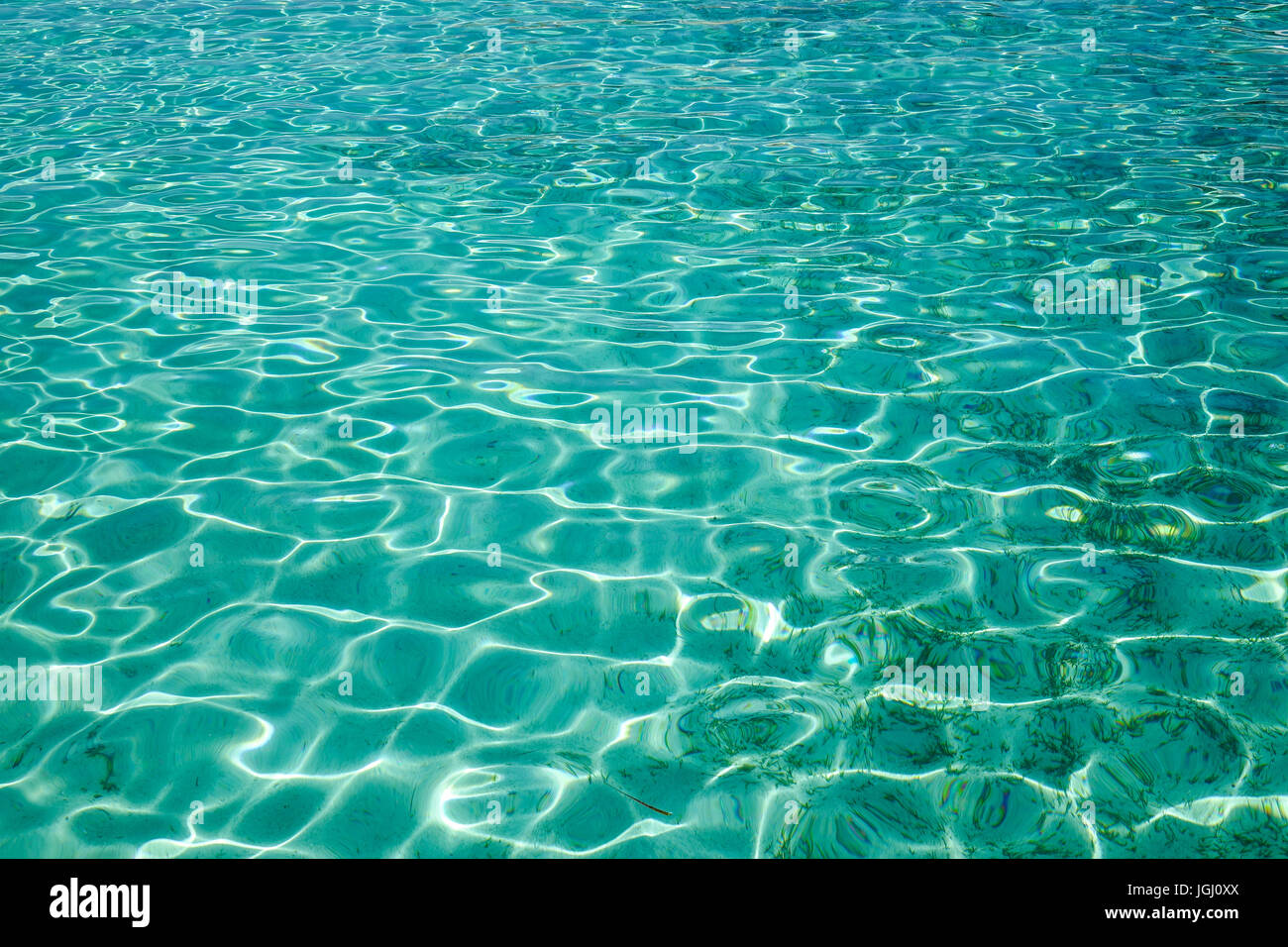 Turquoise water on the sea under sun light in summer. Close up ...