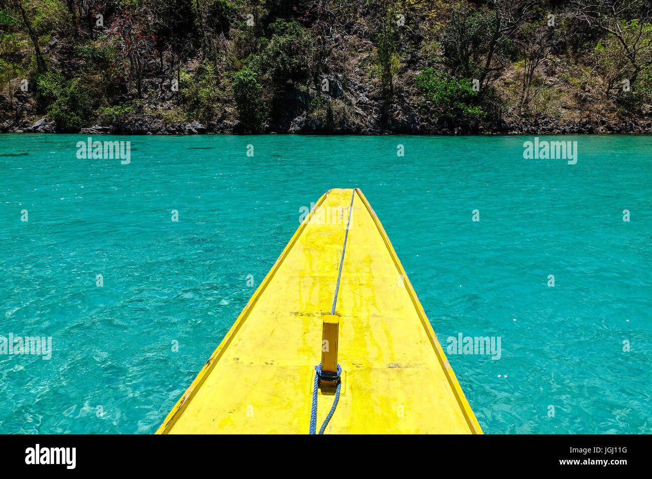 A yellow wooden boat on the sea with turquoise water in summer Stock ...