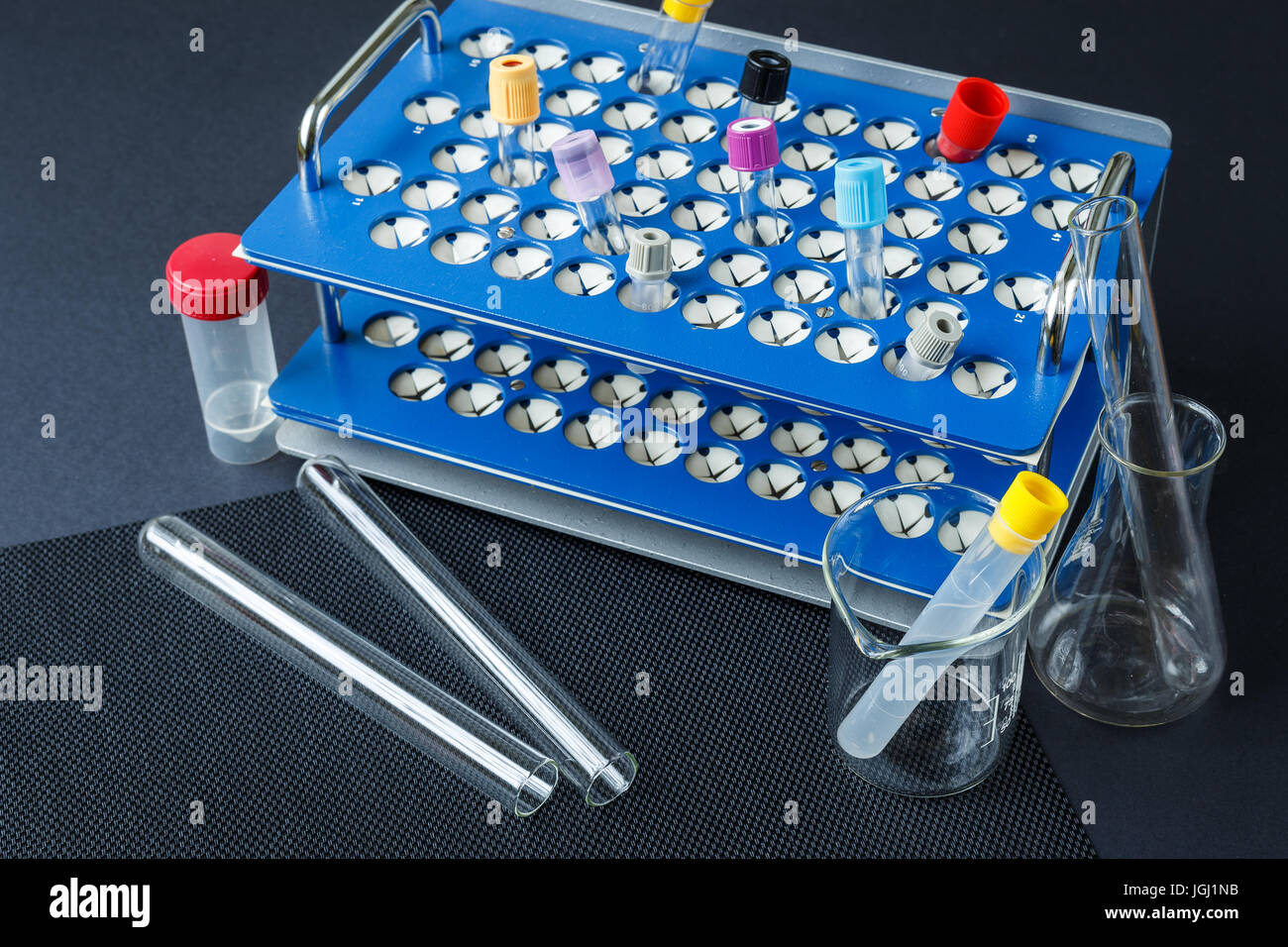 Laboratory glass and color test blood tubes on stand. Medical