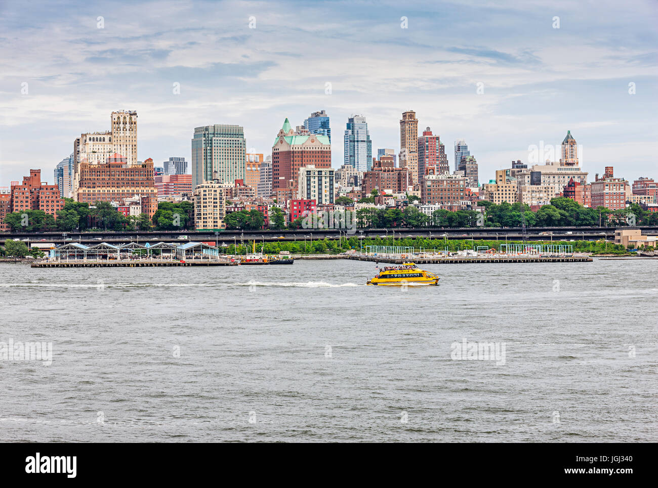Brooklyn skyline, yellow ferry boat sails on East River, New York City Stock Photo