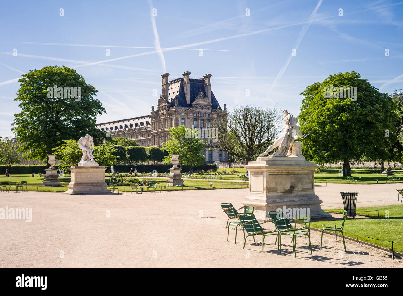 The Tuileries garden in Paris, France, by a sunny morning with the statues of Alexander Fighting and the Good Samaritan and the Louvre palace. Stock Photo
