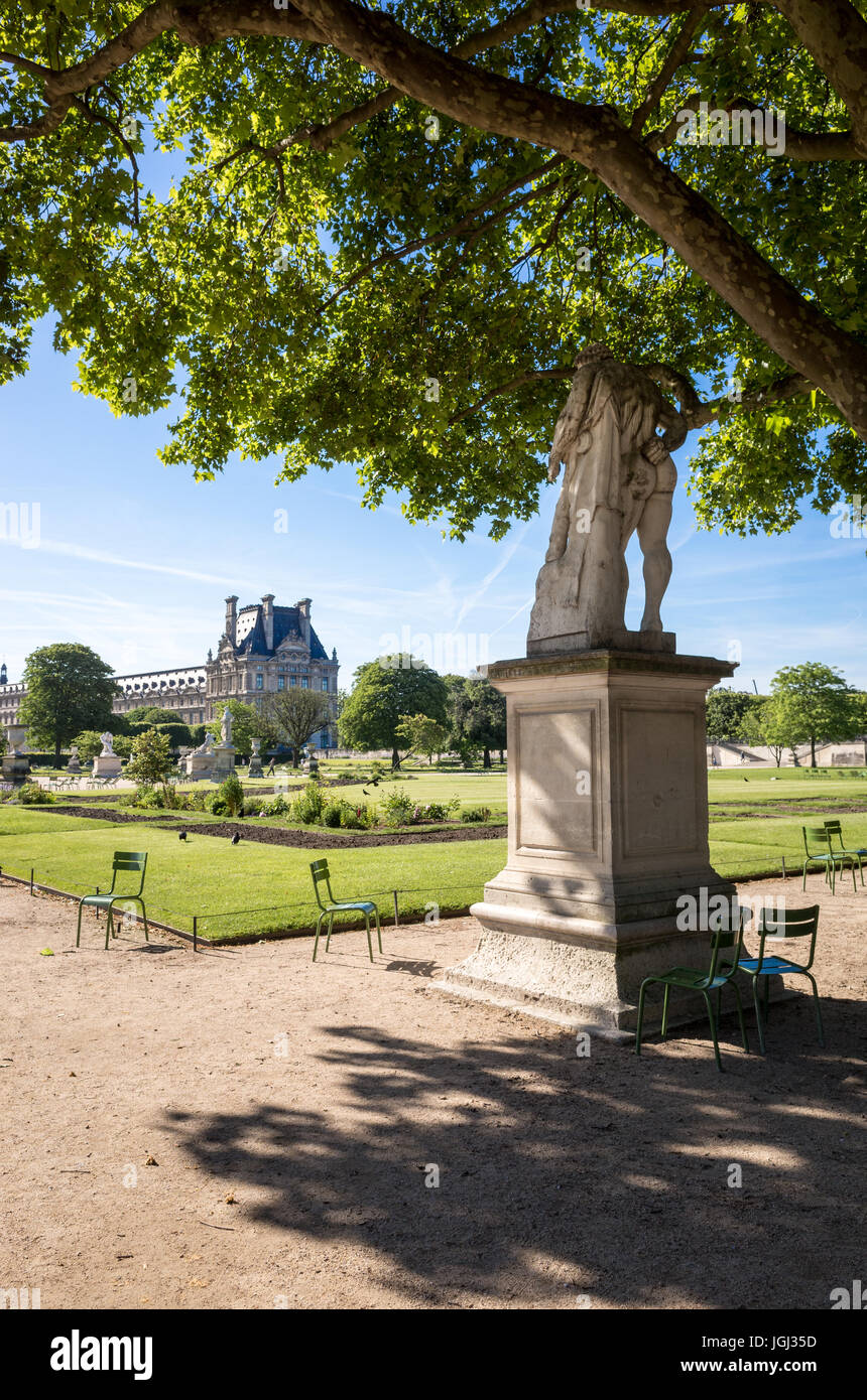 The Tuileries garden in Paris, France, by a sunny morning with the statue of Hercule Resting and the Flore pavilion of the Louvre palace. Stock Photo