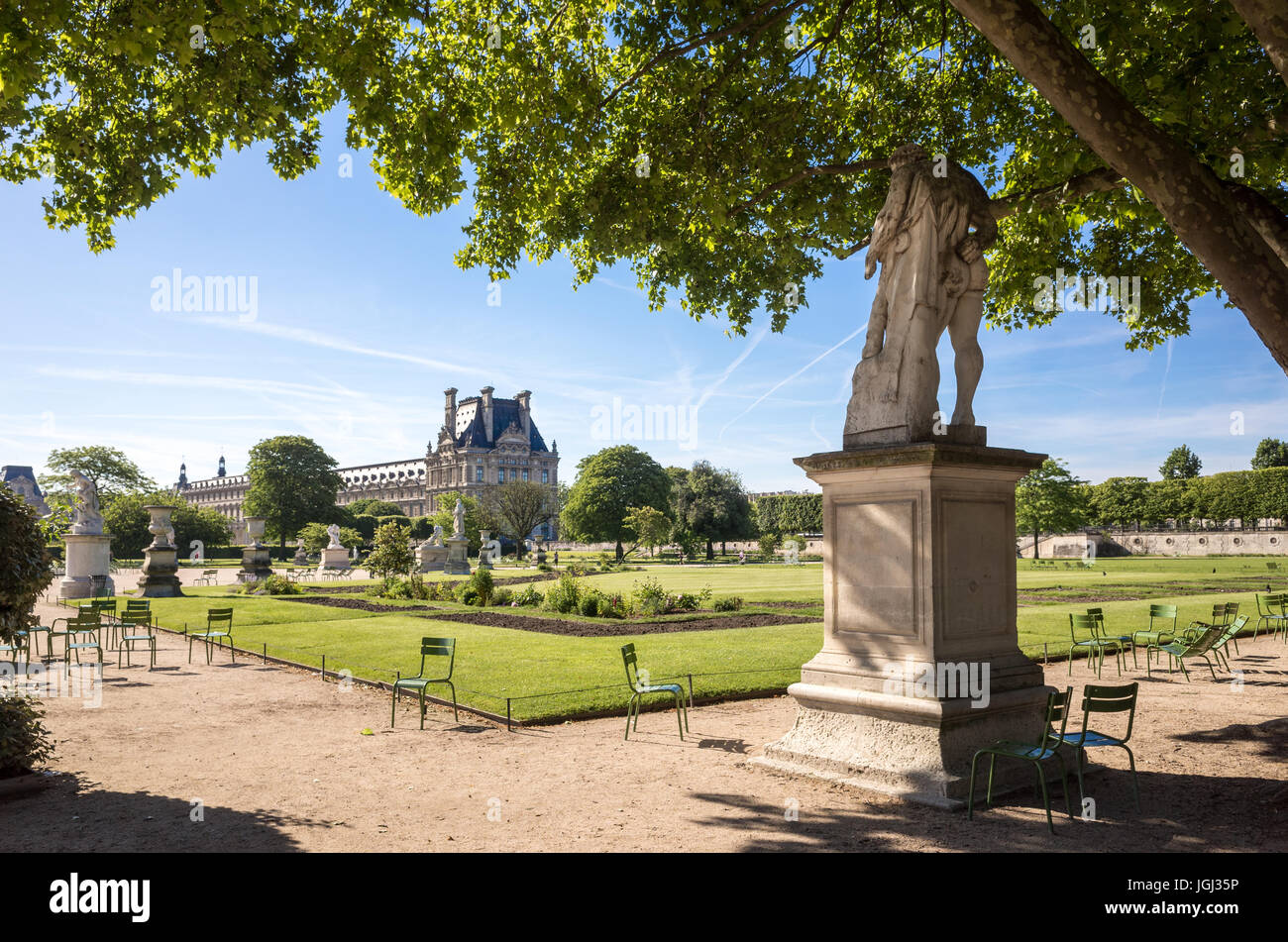 The Tuileries garden in Paris, France, by a sunny morning with the statue of Hercule Resting and the Flore pavilion of the Louvre palace. Stock Photo