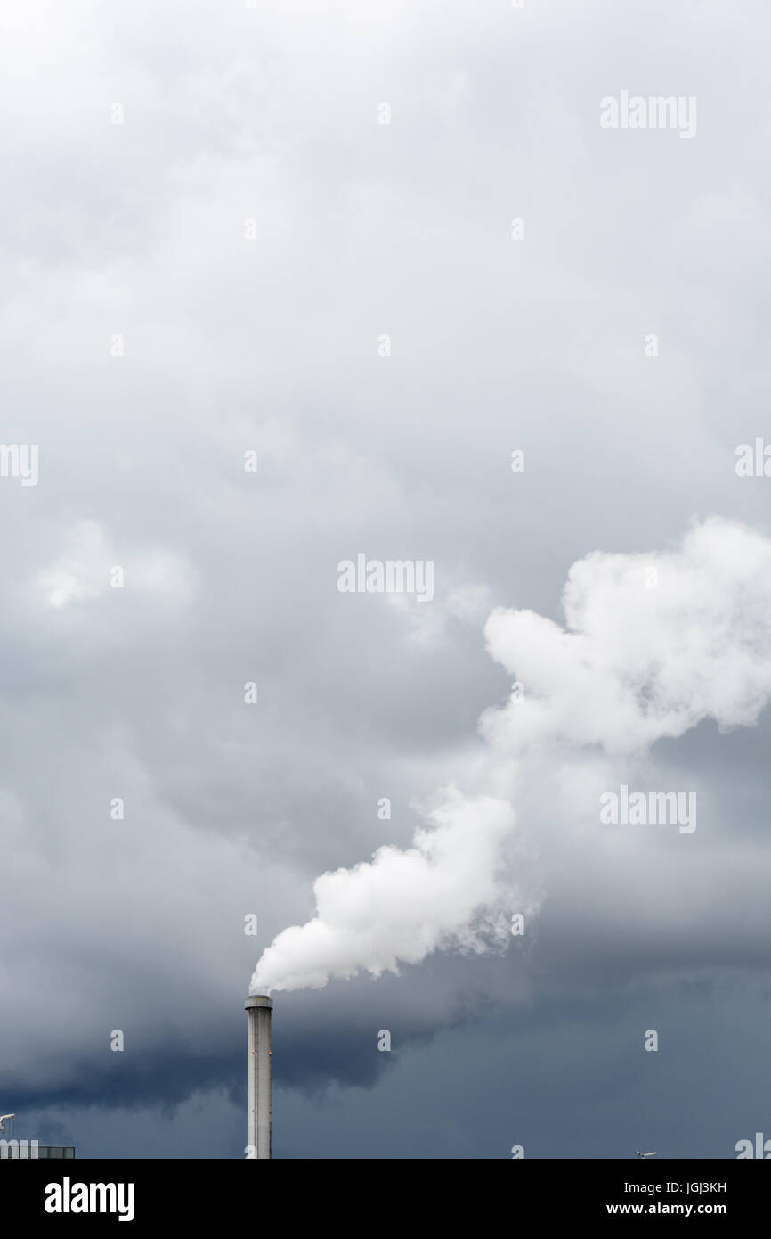 Industrial smoke emission from factory chimney under a stormy sky Stock ...