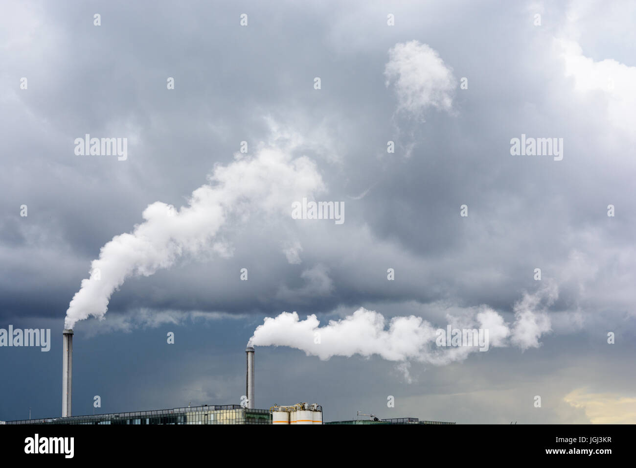 Industrial smoke emission from factory chimney under a stormy sky Stock ...
