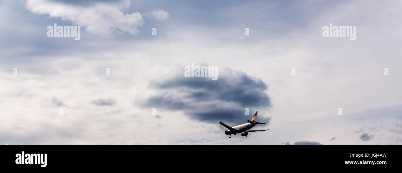 Passenger plane flying in the blue sky with clouds, cruise aircraft ...
