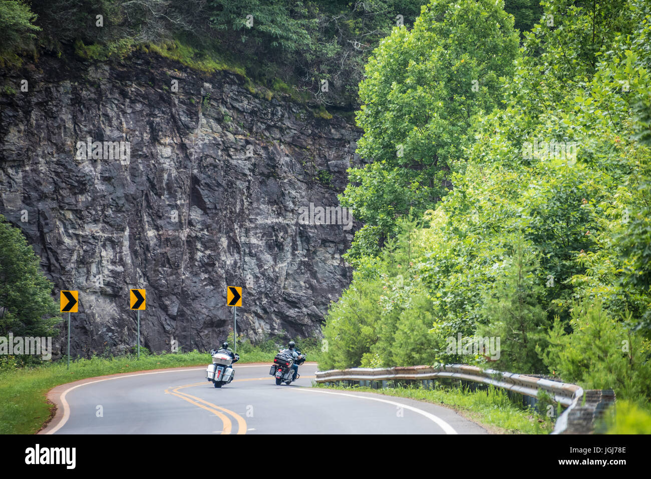 Two motorcyclists enjoying a summer mountain ride on the curvy Richard B. Russell Scenic Highway in the Blue Ridge Mountains of North Georgia. (USA) Stock Photo