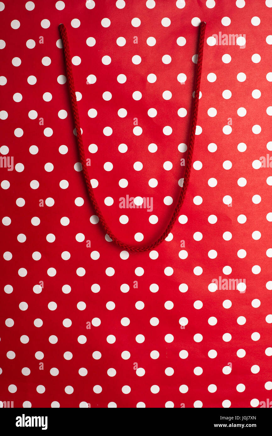 vertical front view of red shopping bag background texture with polka