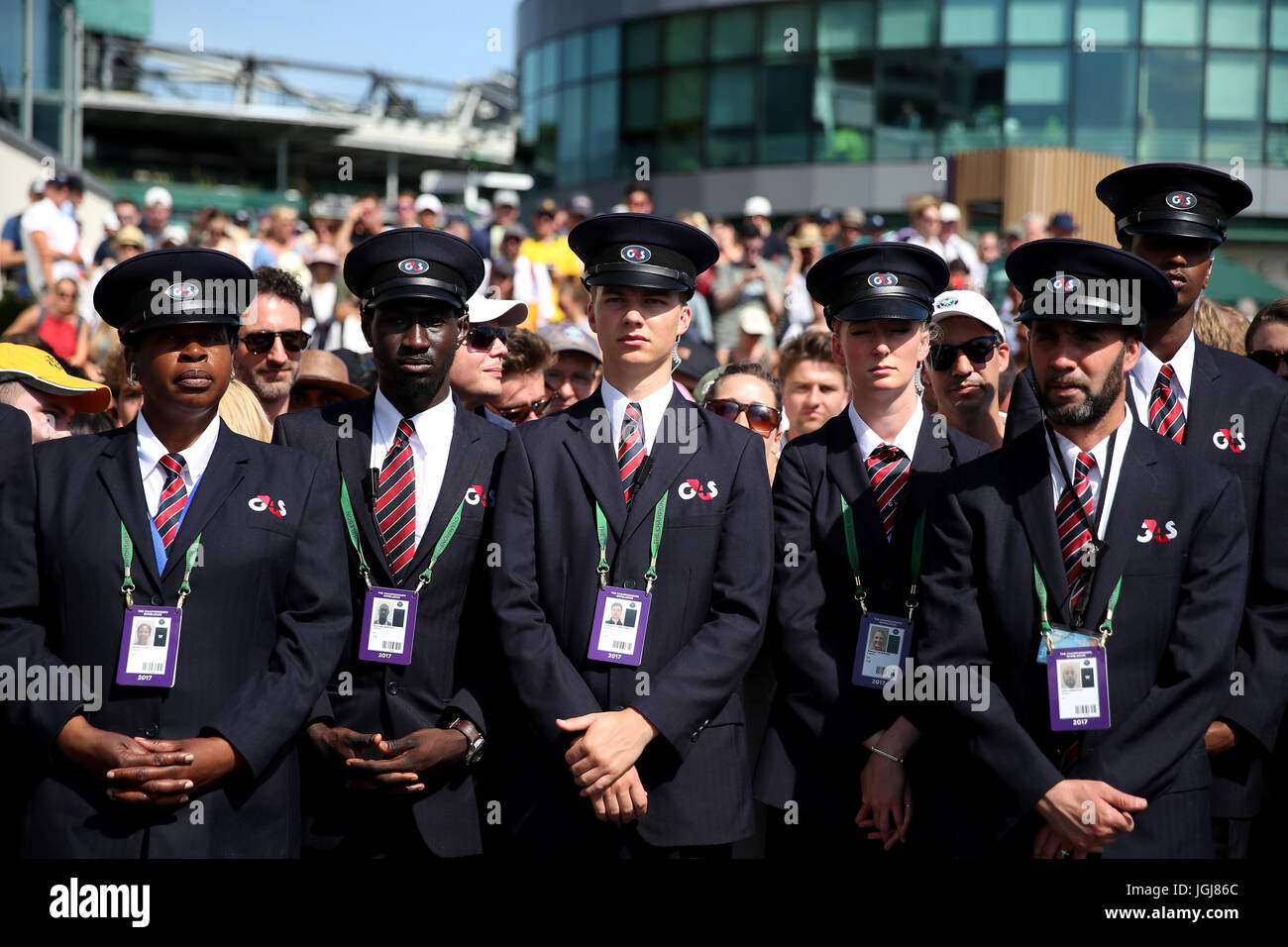 G4S security staff hold back the spectators as they prepare to let them  into the grounds on day five of the Wimbledon Championships at The All  England Lawn Tennis and Croquet Club,