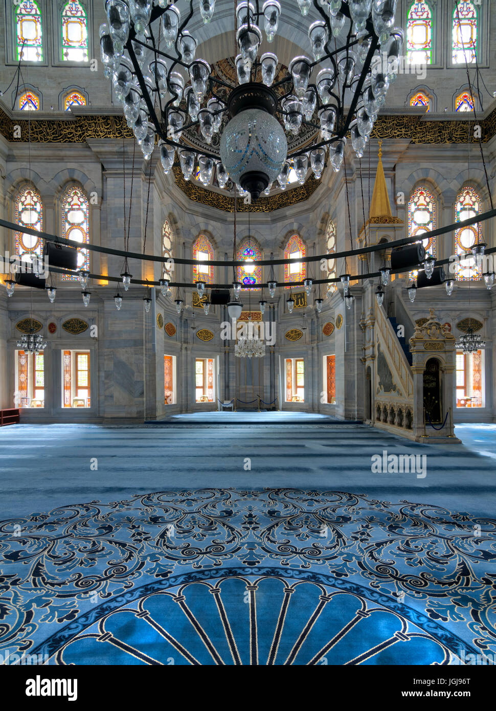 Interior shot of Nuruosmaniye Mosque, an Ottoman Baroque mosque, overlooking niche (Mihrab) and marble minbar (Platform) facade with many colored stai Stock Photo