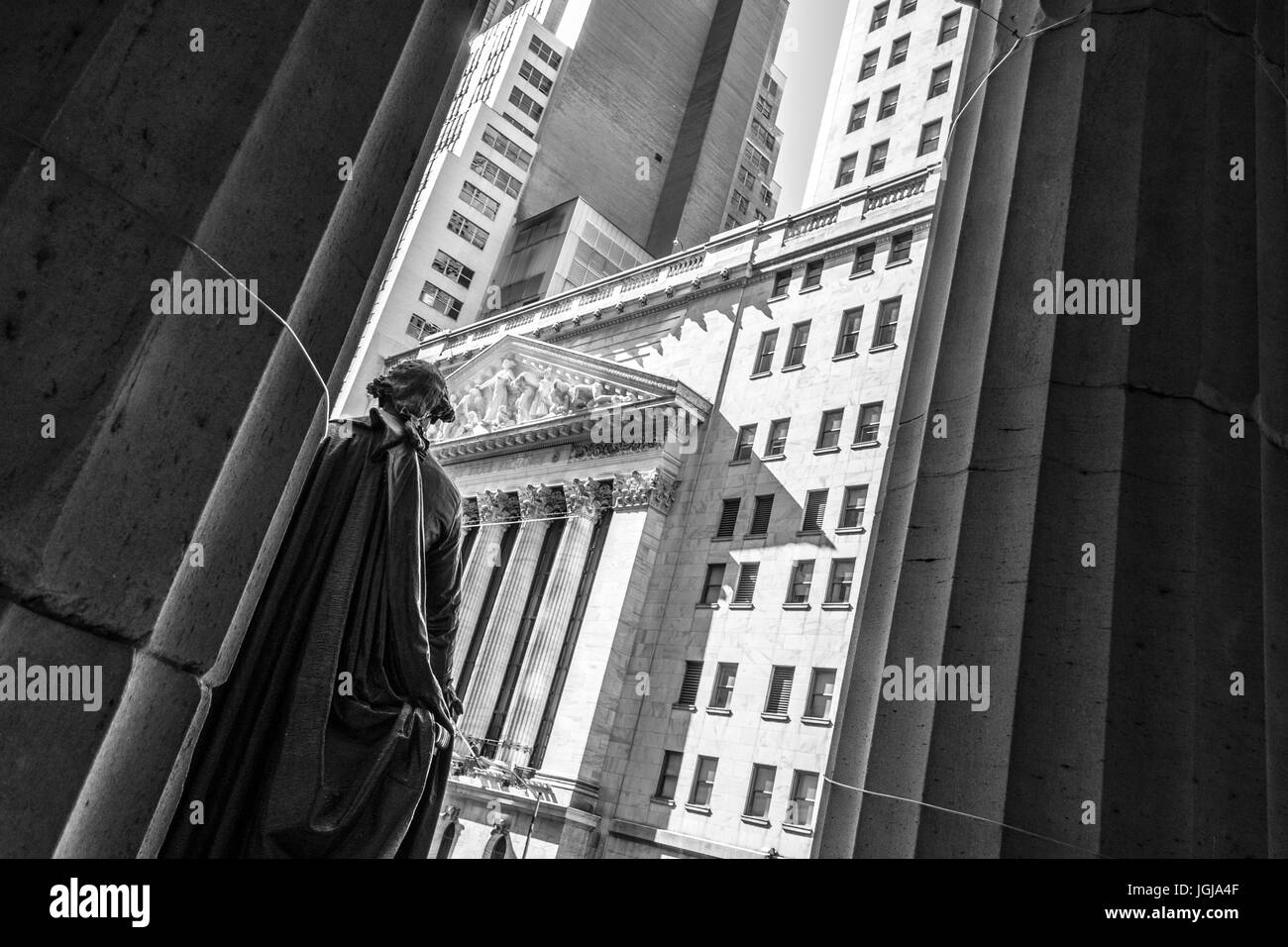 New York Stock Exchange from behind president George Washington statue in Wall street, Manhattan Stock Photo