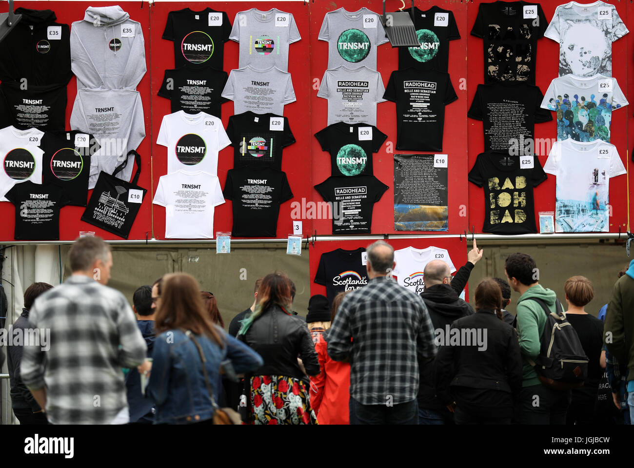 Music fans at a stall selling T-shirts and other merchandise on the ...