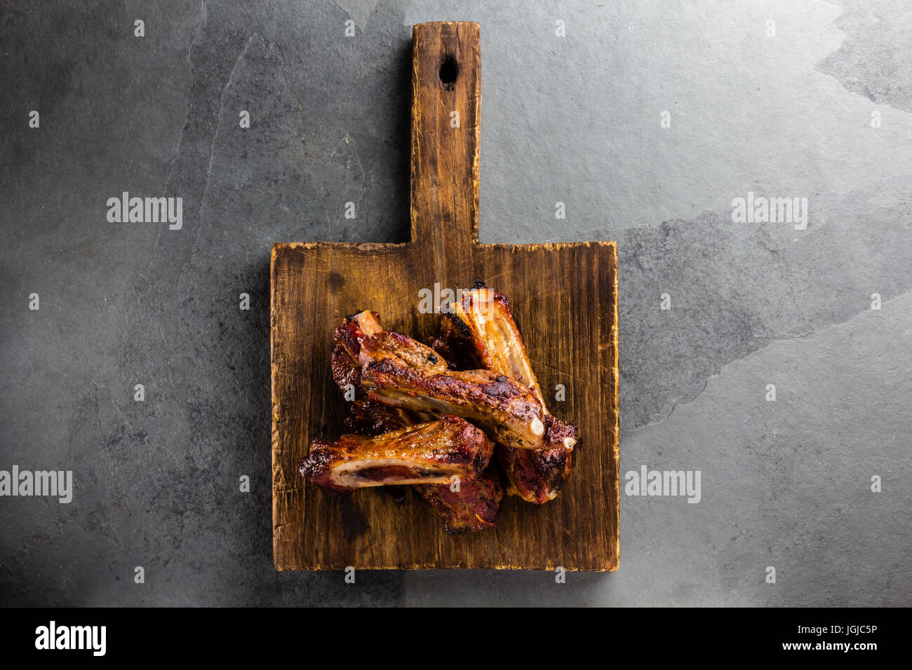 Pork ribs on cutting board, slate background. top view Stock Photo