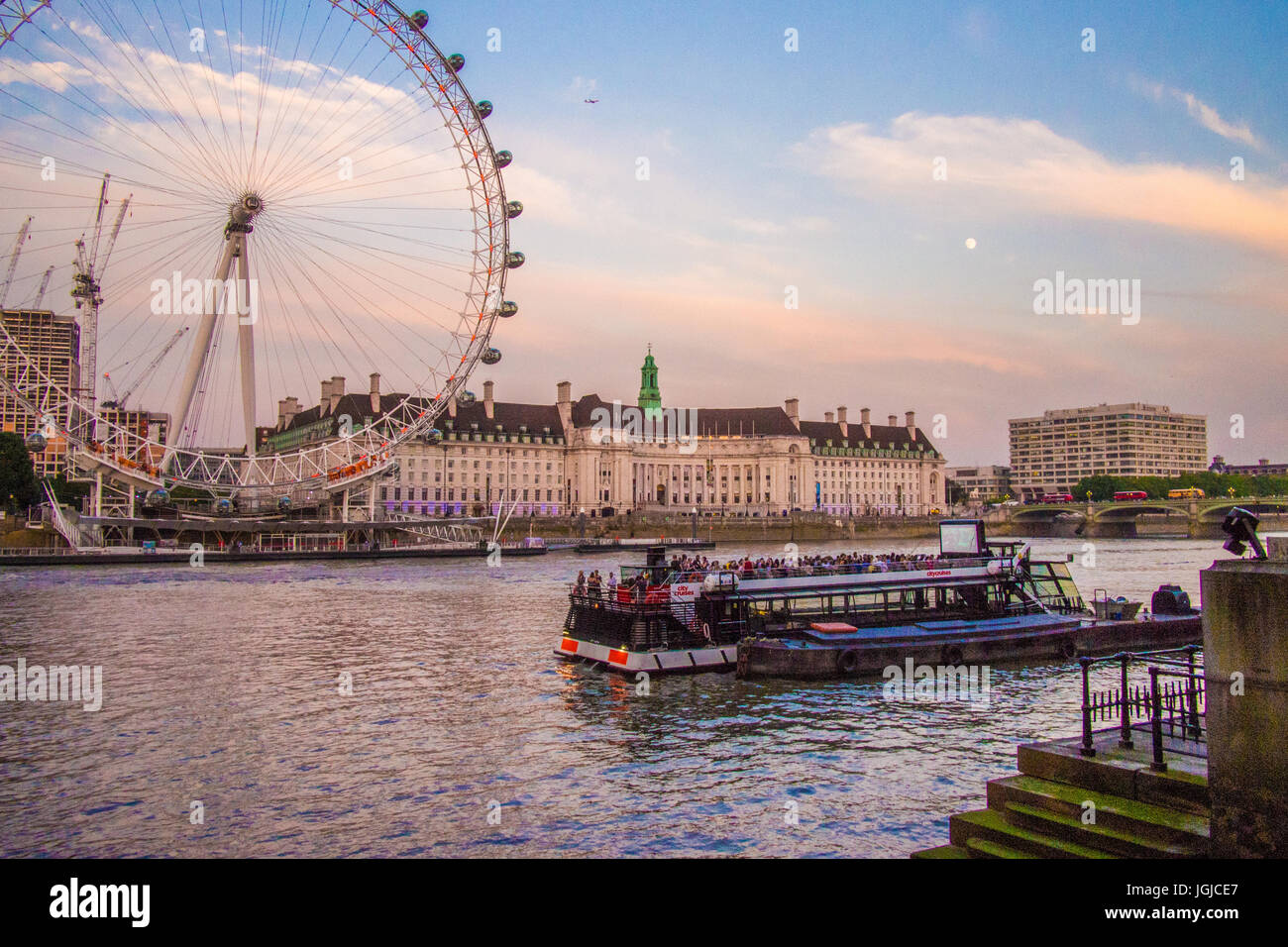 London Eye on the south side of the River Thames with County Hall right, London. Stock Photo