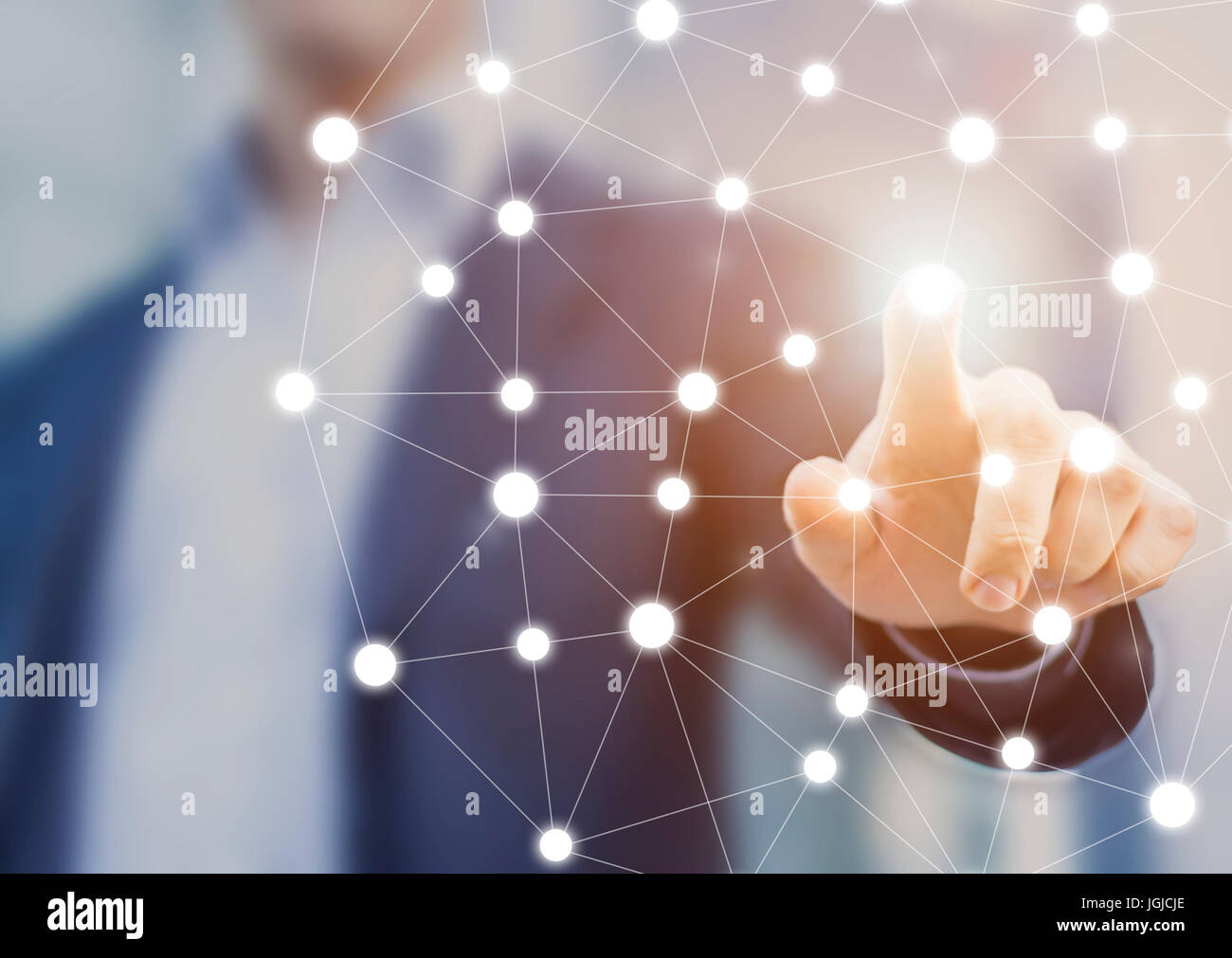 Person touching a network chart showing connections between nodes or servers, concept about the world wide web internet and data communications Stock Photo