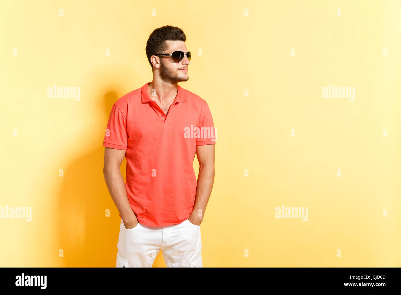 Young brunette man in sunglasses posing looking away Stock Photo - Alamy
