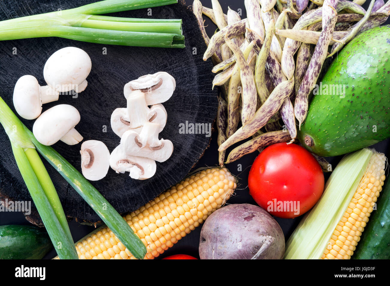 Plenty of fresh vegetables on black wooden background Stock Photo