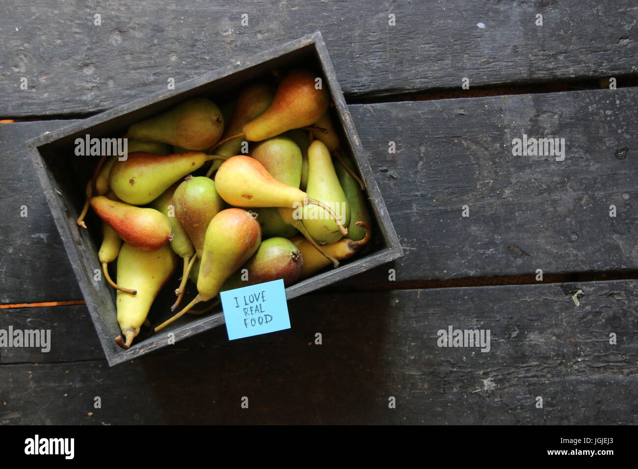 I love real food label and Pears in wooden box on table Stock Photo