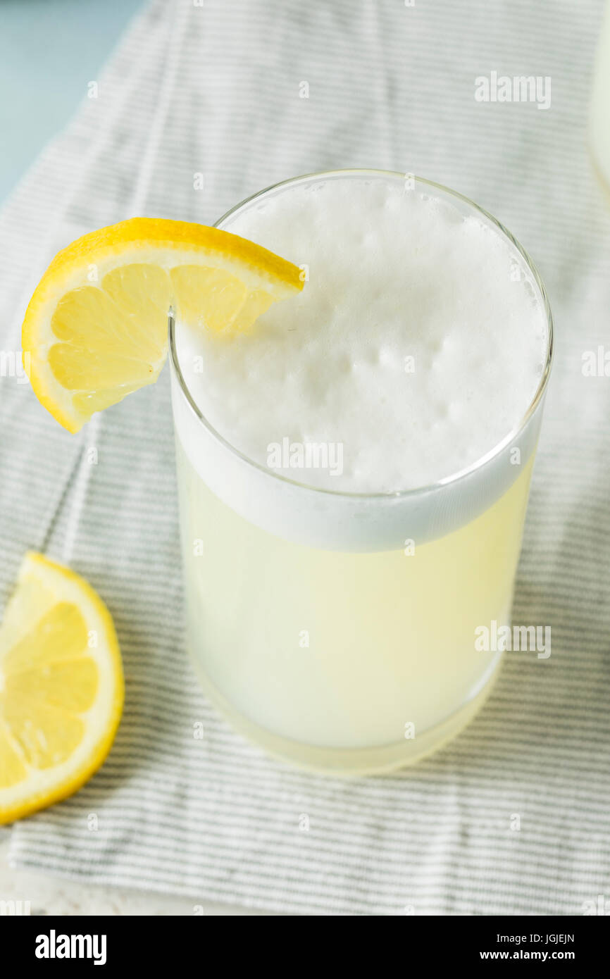Refreshing Cold Egg Gin Fizz with a Lemon Garnish Stock Photo Alamy