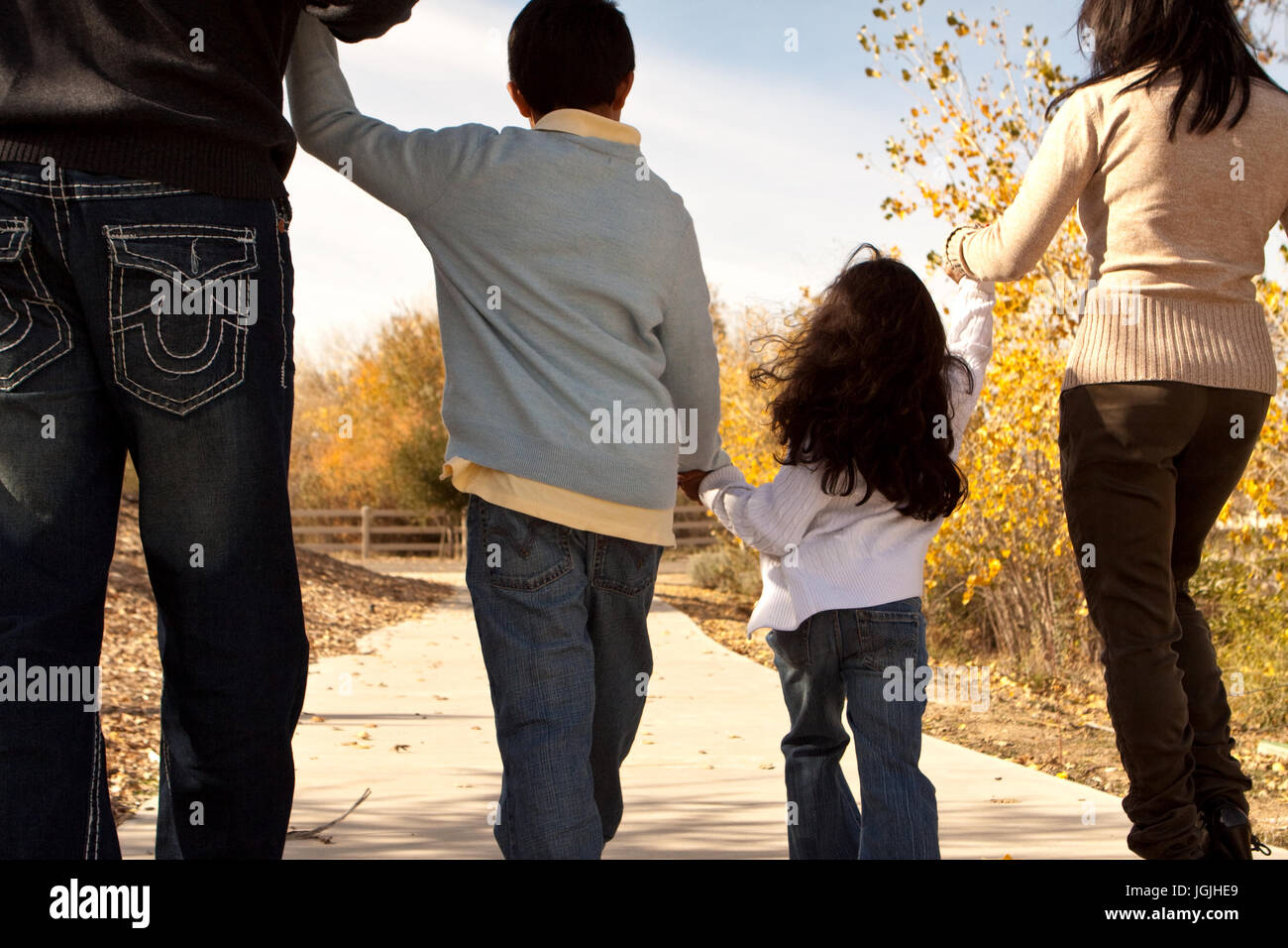 Rear view of a happy family taking a walk Stock Photo - Alamy