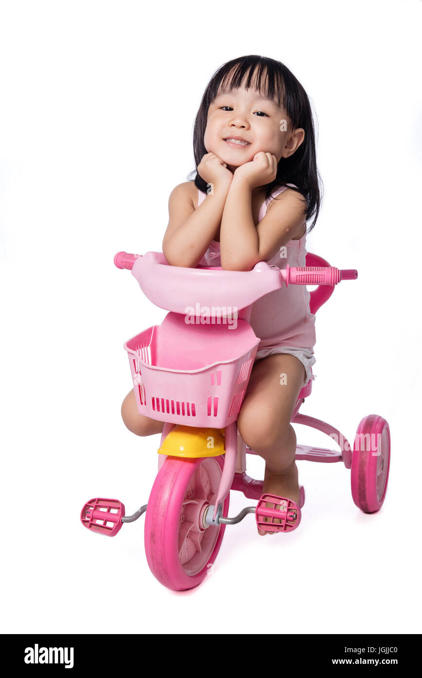 girl riding tricycle