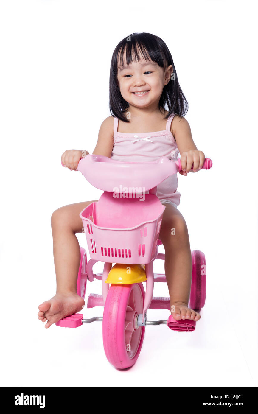 girl riding tricycle